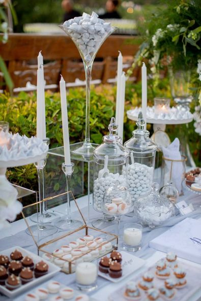 Close up shot of wedding dessert table with white and metallic details.
