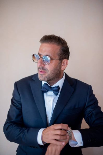 Australian groom with tuxedo and glasses.