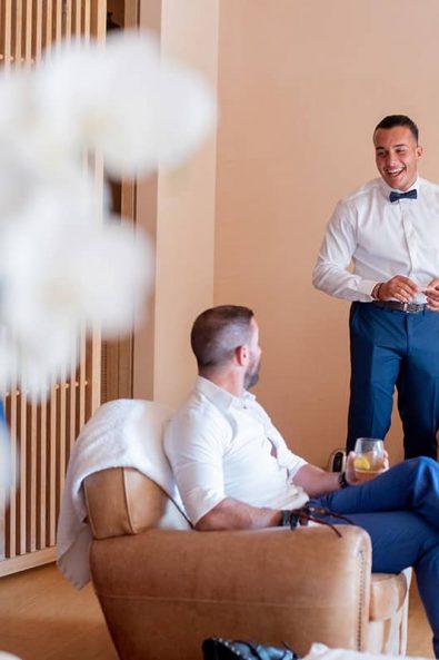 Groomsmen and best man drinking whiskey before the wedding ceremony.