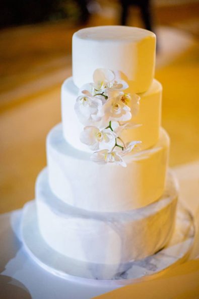 Elegant and luxurious white and gray marble wedding cake with orchids for a summer destination wedding in athenian riviera.