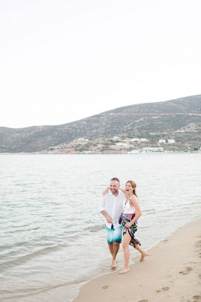 Pre-wedding beach shoot with bride and groom walking and playing on the beach.
