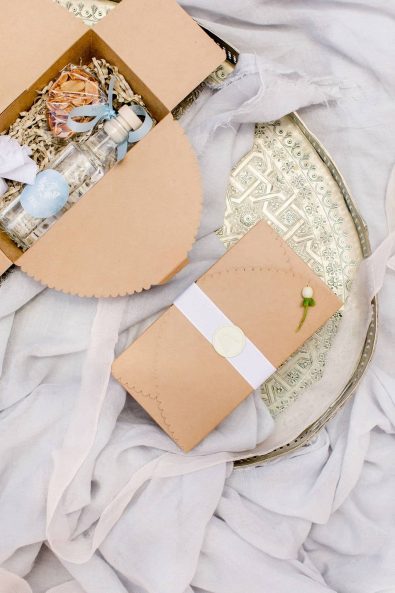 Close up shot of welcome gift boxes with Greek traditional products and white seal wax stamp.