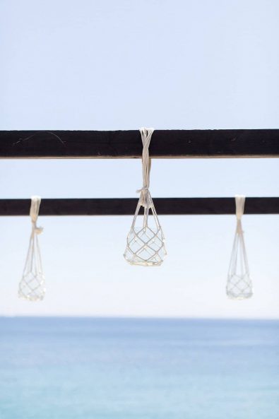Cord macrame candle holders for a summer wedding reception by the sea.