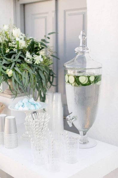 Glass jar with pump and cucumber flavored water.