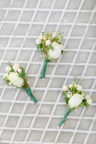 Close up shot of white rose flower boutonniere.