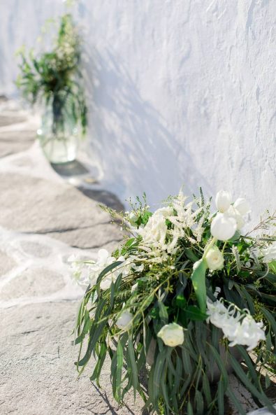 Summer flower wedding decoration arrangements with greenery, eucalyptus, and white flowers.