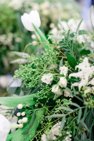 Elegant organic chic wedding white flower decoration arrangements with greenery and eucalyptus.