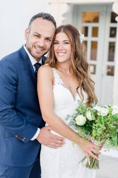 Beautiful wedding portrait of smiling bride and groom after their island chic destination wedding in Sifnos, Greece.