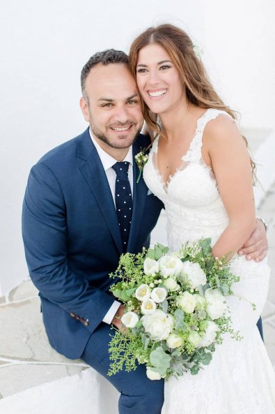 Just married bride and groom looking a the camera smiling after their island chic wedding.