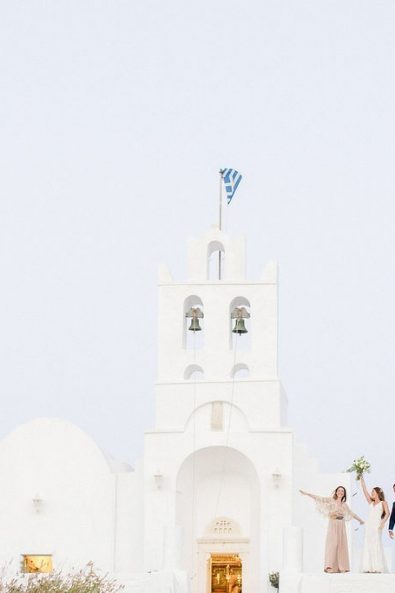 Bride, groom, best man and best woman celebrating after the wedding out of the picturesque white chapel in Sifnos island Greece.