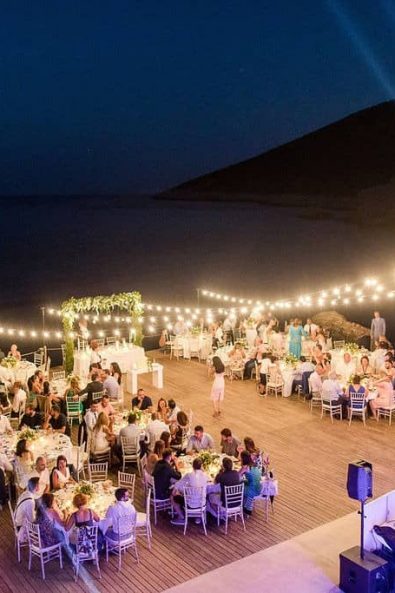 After wedding party reception by the sea with fairy lights.