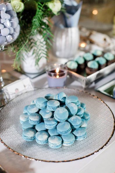 Marbled blue macarons on a gilder glass serving tray.