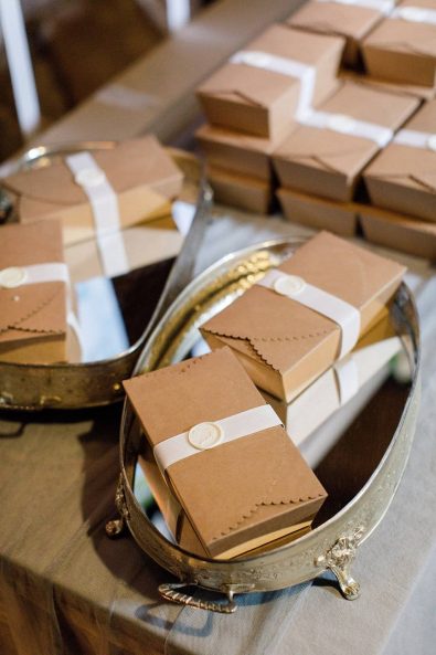 Wedding favors party guest gilts in craft paper boxes with a white wax seal.