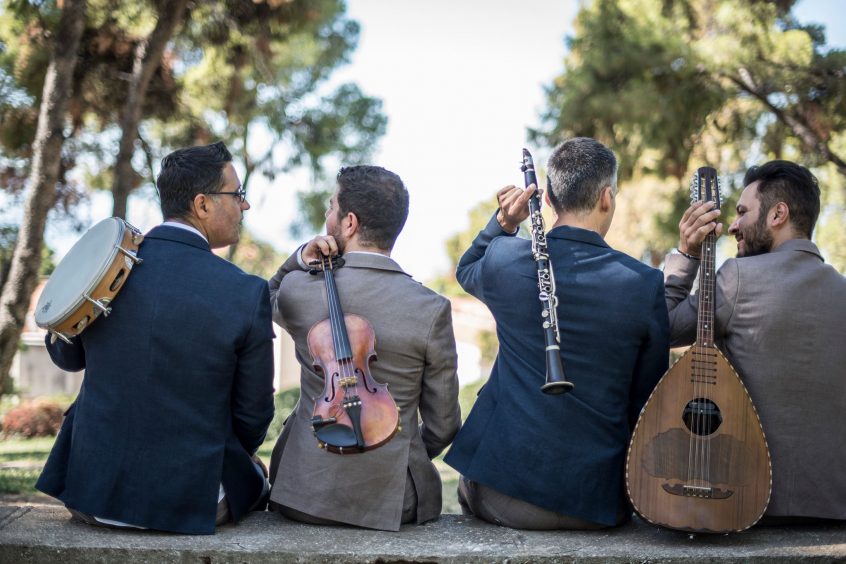 Wedding band bratimia sitting with their musical instruments on their backs