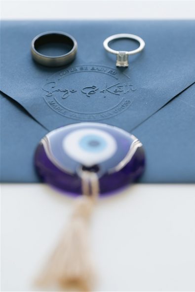 Evil eye charm and wedding rings