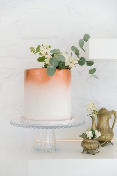 wedding cake with flowers and copperware