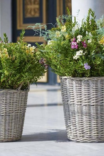 Church decoration with flower arrangements in baskets with summer and spring flowers.