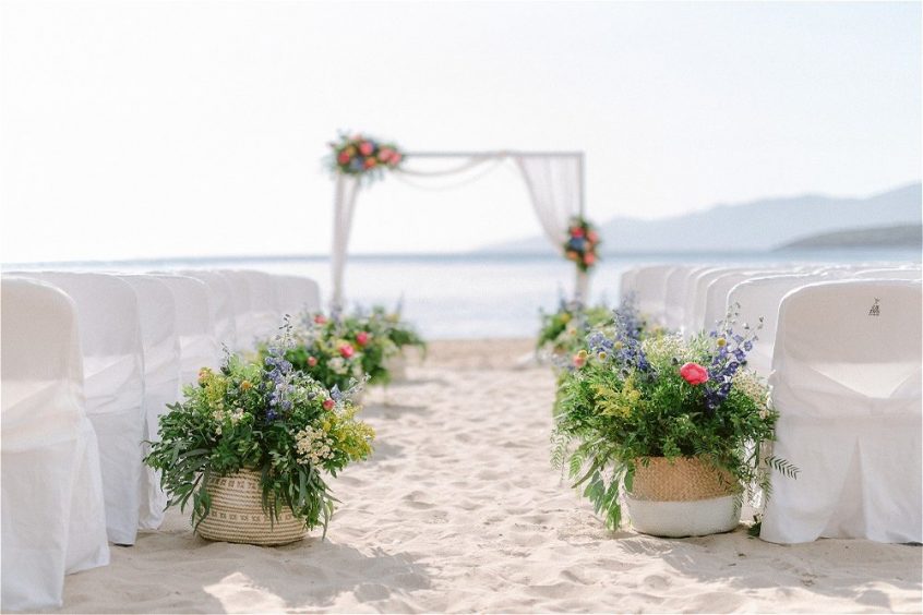 Ceremony on the beach decorated with beautiful flower arrangements 