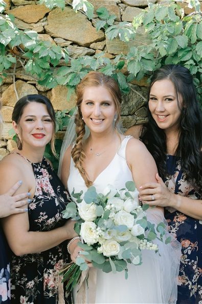 Bride and bridesmaids posing in a destination wedding in Ios