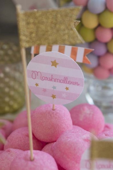 Pink marshmallows with gold flag topper decorations.