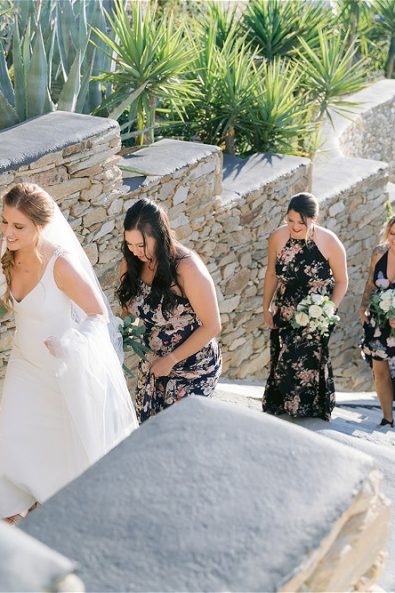 Bride and bridemaids walking up stone stairs