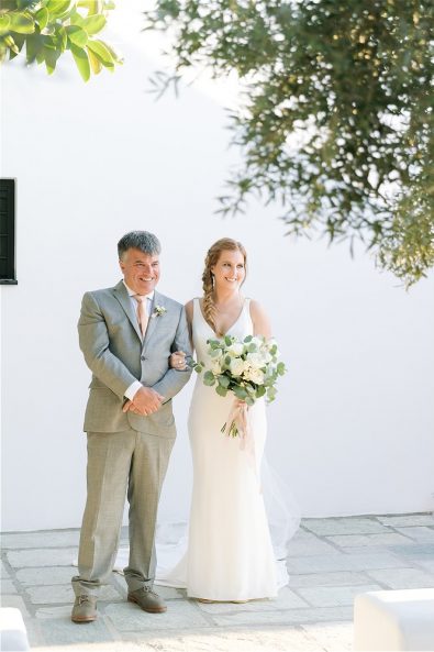 Bride with her father holding flowers