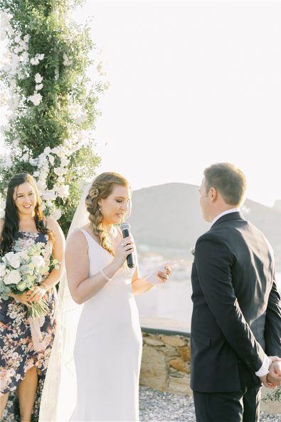 Bride reading vows to groom at destination wedding in Ios