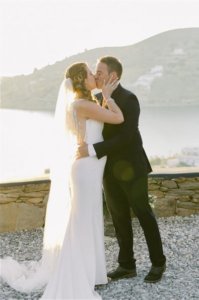 Bride and groom kissing in a destination wedding in Ios