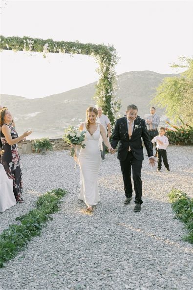 Bride and groom walking on stone road