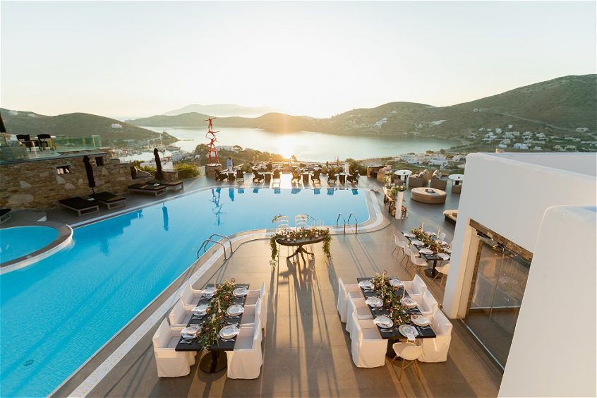 View from height of pool and wedding tables at destination wedding in Ios