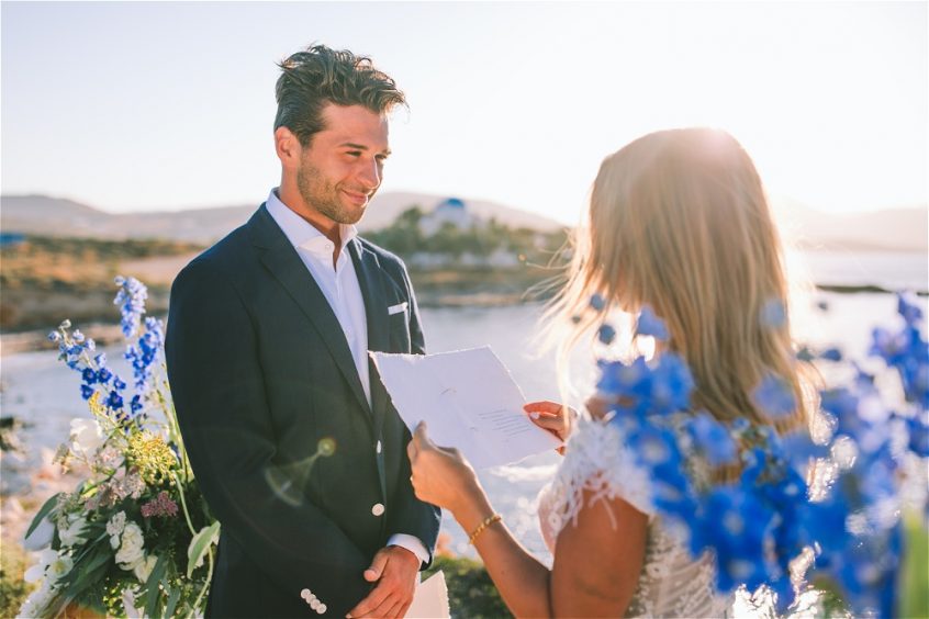 bride and groom getting married surrounded by flowers