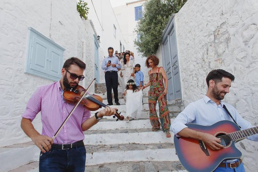 wedding in hydra couple walking down stairs with band